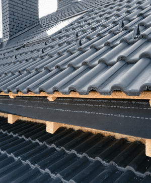 closeup house roof top covered with ceramic shingles tiled covering building construction